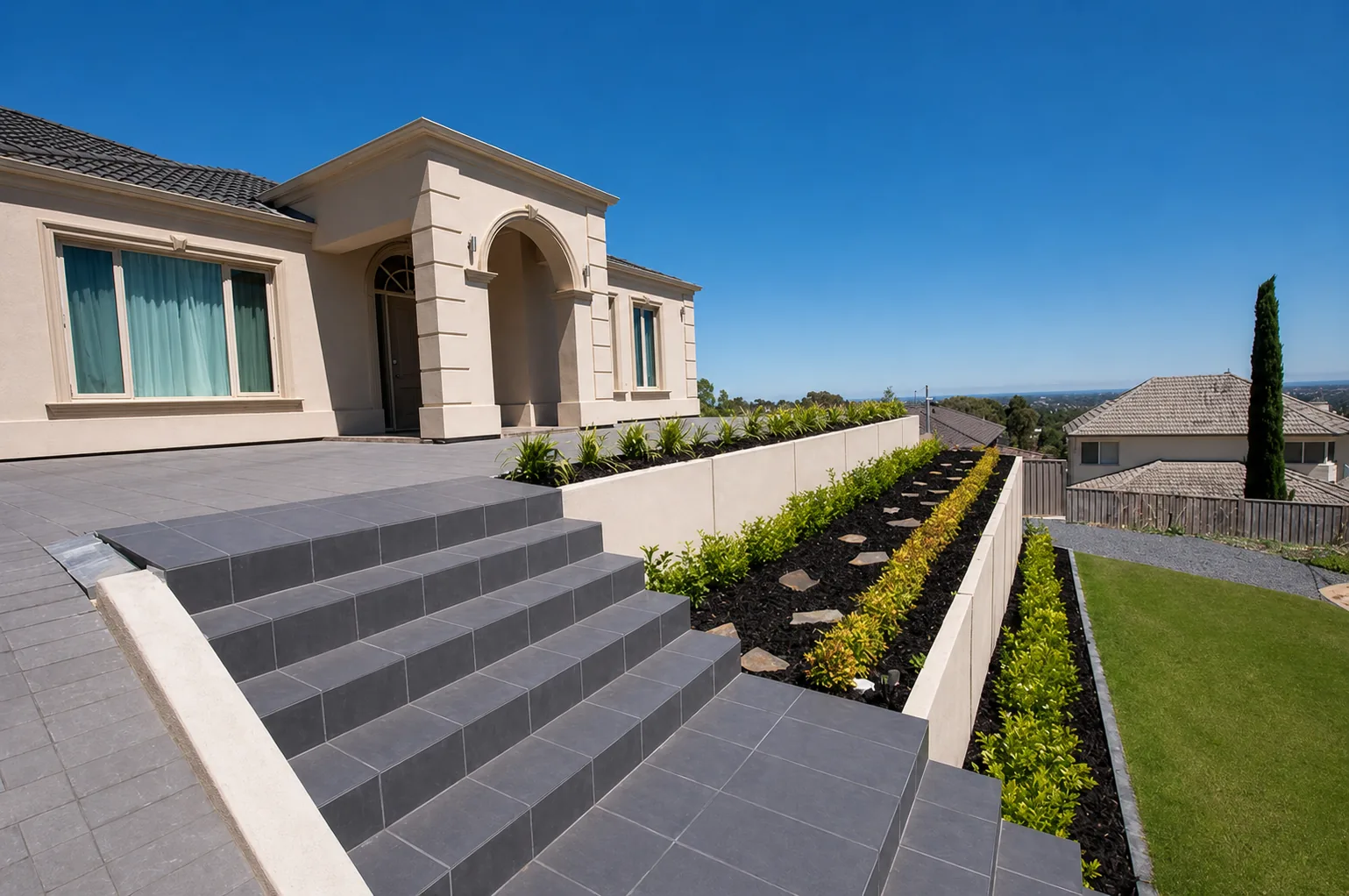 Terraced front entry with charcoal tiled steps and structured planting