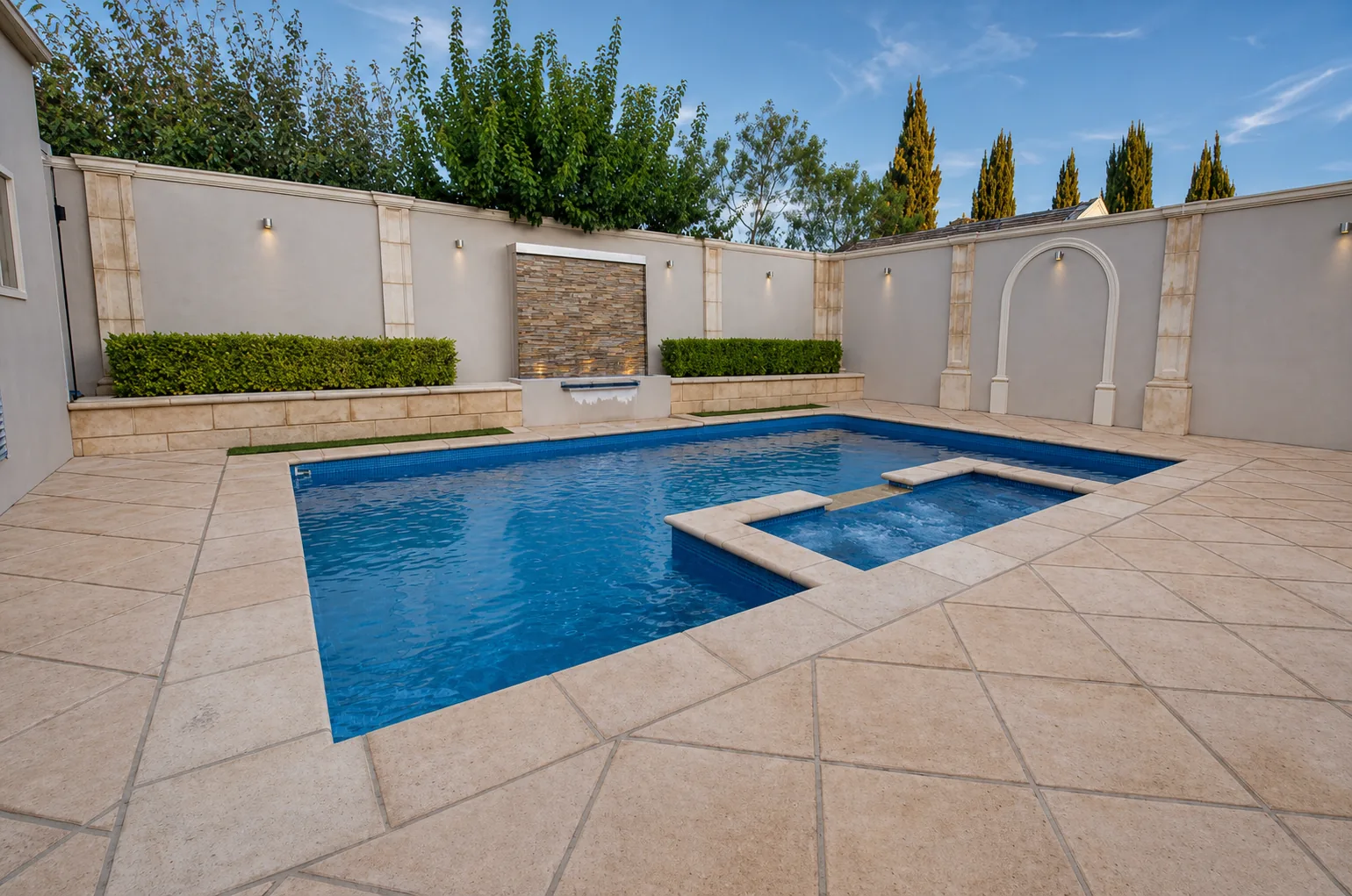 Completed swimming pool, spa and masonry water-feature courtyard